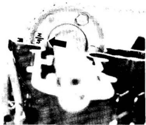 Black-and-white photo of a person's head with arrows pointing to the head area, no visible text or symbols
