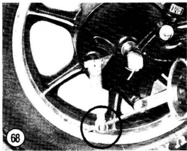 Black-and-white illustration of a car wheel with a person inside, showing no visible text or symbols.