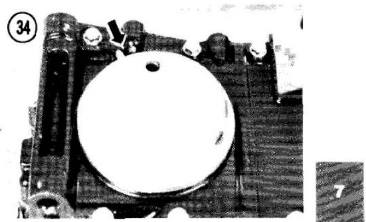 Close-up of a mechanical component with a circular white object and two protruding components, no visible text or symbols.