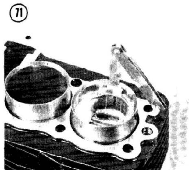 Close-up of an engine cylinder head with cooling fins and mounting flanges (no visible text or symbols)