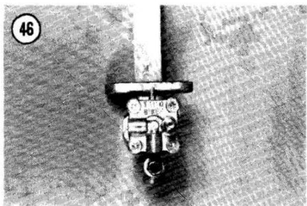 Close-up of a mechanical component with a lever and base, no visible text or symbols