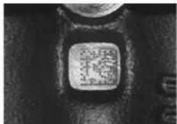 Close-up of a small square button with Chinese characters, likely a button or label.