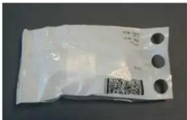 White plastic bag with three circular holes and a QR code on the side, likely a label or barcode.