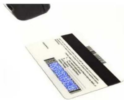 Scanned document with blue QR code on a white surface, partially visible text and a black barcode strip.