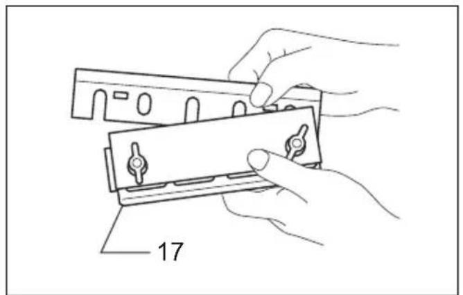 Line drawing of hands holding a mechanical component with a numbered label (17), no text or symbols present.