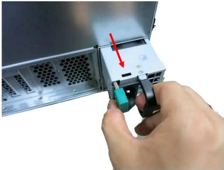 Hand inserting a device into a server rack, showing a red arrow indicating the component (no text or symbols visible)