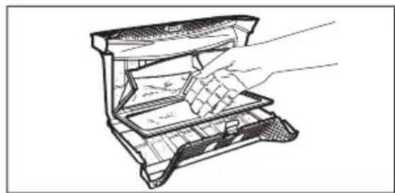 Line drawing of a hand inserting a component into a device (no text or symbols)