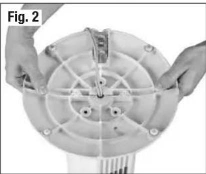 Close-up of hands installing or adjusting a circular mechanical component with a central hub (no text or symbols visible)