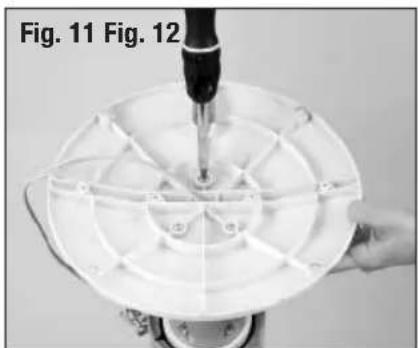 Close-up of a hand using a screwdriver to adjust or install a circular component, labeled Fig. 11 and Fig. 12 (no text on the diagram itself)