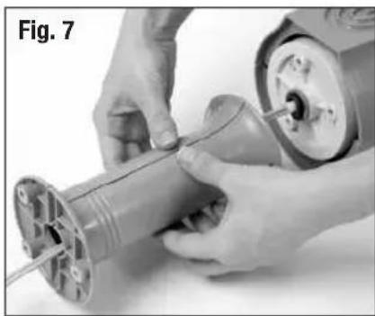 Close-up of hands assembling a mechanical component, no visible text or symbols