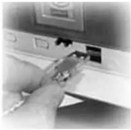 Close-up of a hand inserting a card into a device (no visible text or symbols)