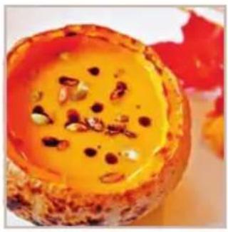 Close-up of a baked dessert with orange sauce and sesame seeds, no visible text or symbols