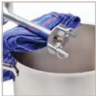 Close-up of a kitchen utensil holding a blue cloth over a white pot (no text or symbols visible)