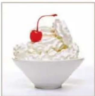 White bowl of whipped cream with a red cherry on top (no text or symbols visible)