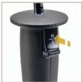 Close-up of a black cylindrical device with a lid and handle, no visible text or symbols