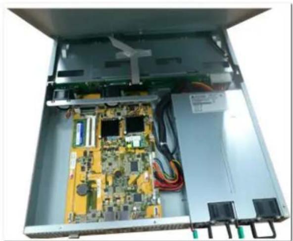Interior view of an open electronic device showing a circuit board with multiple components and wiring (no visible text or symbols)