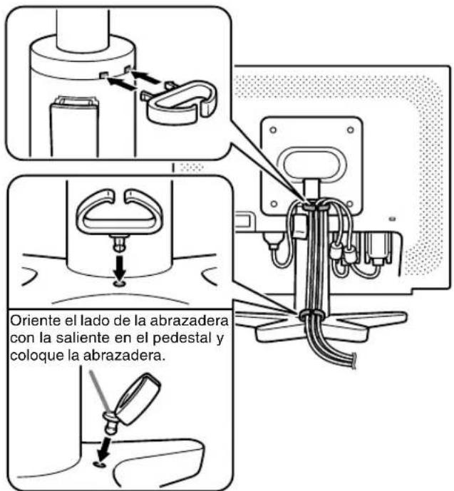 Oriente el lado de la abrazadera con la saliente en el pedestal y coloque la abrazadera.