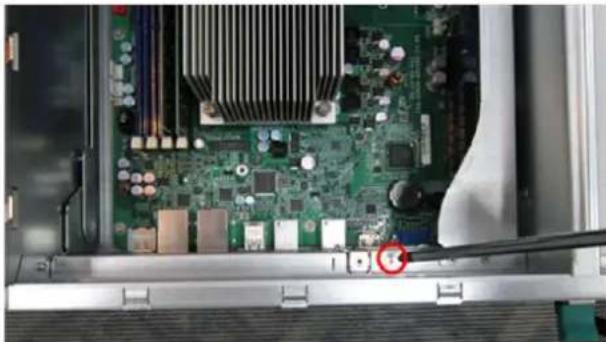 Close-up of an open computer motherboard showing green circuit board and surrounding hardware (no visible text or symbols)