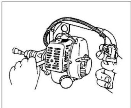 Line drawing of hands operating a mechanical device with hoses and connectors (no text or symbols)