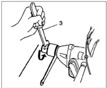 Technical diagram showing a hand using a wrench to adjust a mechanical component, labeled with number 3