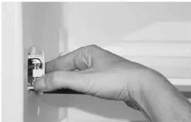 Close-up of a hand holding an electrical socket or socket component (no visible text or symbols)