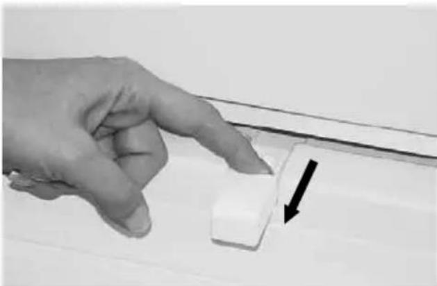 Hand pointing at a white cylindrical object with an arrow indicating direction (no text or symbols visible)