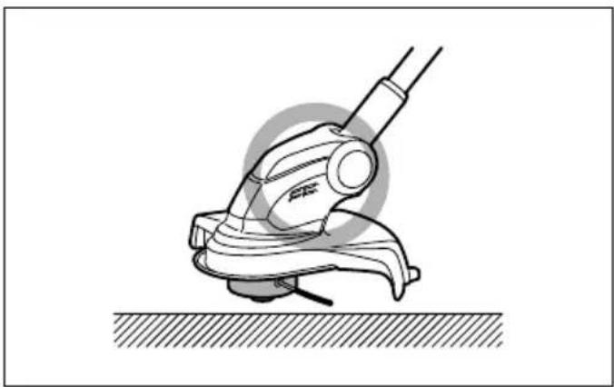 Technical line drawing of a mechanical device with lever and base, resting on a surface (no text or symbols)