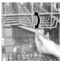 Black-and-white photo of a hand holding a pen, partially obscured by a blurred architectural grid structure.