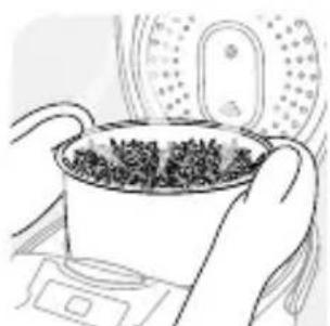 Illustration of hands holding a pot with dark granular substance inside, placed on a stove (no text or symbols)
