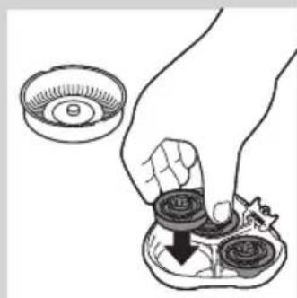 Illustration of a hand holding a small mechanical component with a magnified inset showing a circular component (no text or symbols)