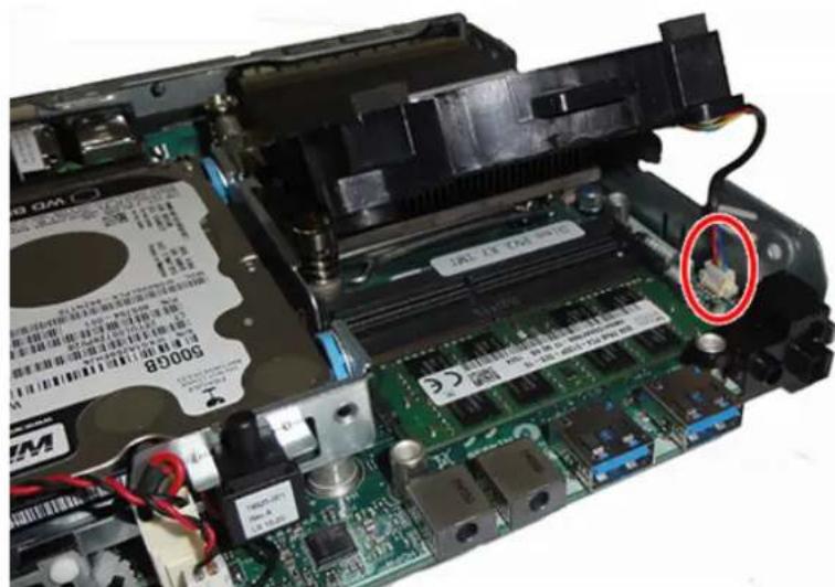 Close-up of an open computer motherboard with a highlighted component (no readable text or symbols)
