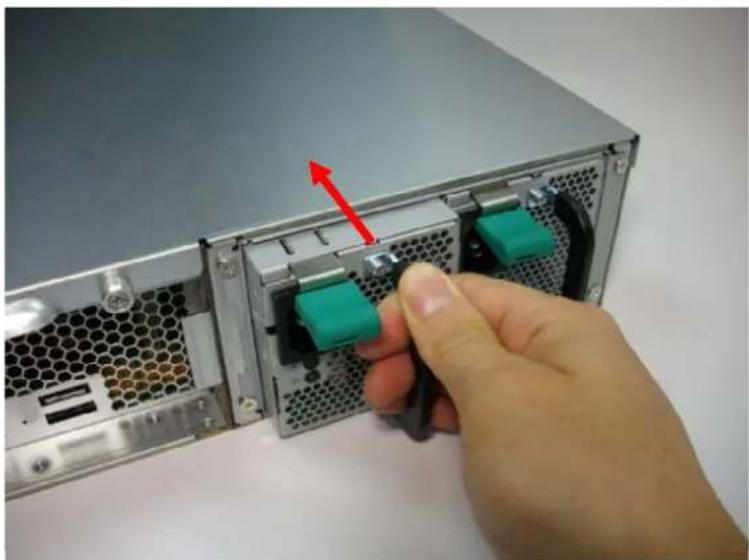 Close-up of a server rack with two green connectors and a hand inserting a cable (no text or symbols visible)