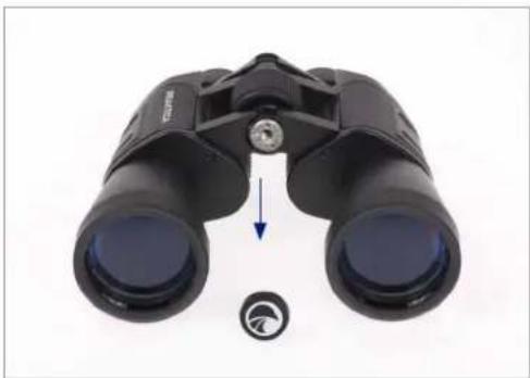 Black binoculars with a blue arrow pointing to the lens, and a small circular icon below (no text or symbols visible)