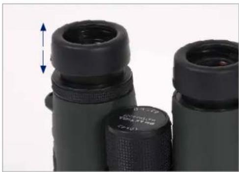 Close-up of black binoculars with a blue vertical arrow indicating measurement (no text or symbols on the objects)
