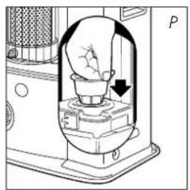 Diagram of a device interior with a hand holding a small object, showing no text or symbols.