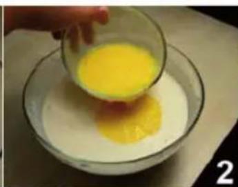 Hand pouring yellow liquid into a glass bowl containing white liquid (no text or symbols visible)
