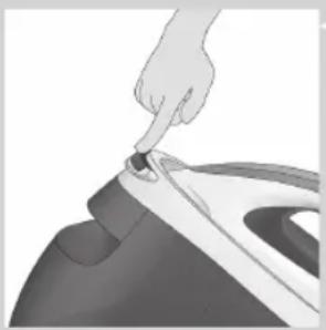 Hand using a tool to press down a garment piece, no text or symbols visible