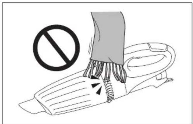 Safety warning illustration showing a hand using a tool to remove debris with a prohibition symbol