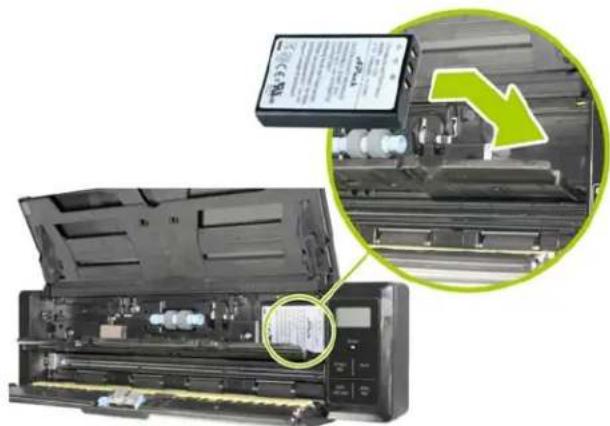 Interior view of a printer with an open circuit board and a green arrow indicating a process or operation (no visible text or symbols)