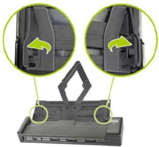 Close-up of a black plastic container with two green circular arrows indicating internal components (no text or symbols)