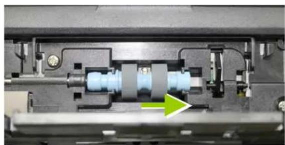 Close-up of a mechanical assembly with internal components and a green arrow indicating a specific part (no visible text or symbols)