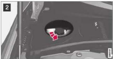 Close-up of a mechanical component with a circular opening and a red arrow pointing to a small feature (no visible text or symbols)