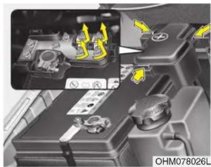 Close-up of a car battery panel with highlighted components and directional arrows indicating assembly or repair (no readable text or symbols)