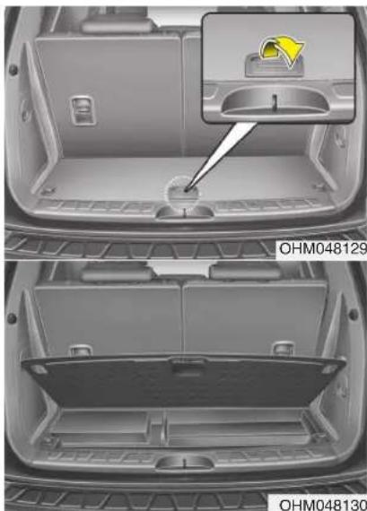 Interior view of a car showing a rear bumper with a highlighted component and a close-up of the lid (no text or symbols visible)