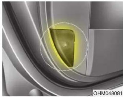 Close-up of a car interior with a highlighted green triangular object, no visible text or symbols