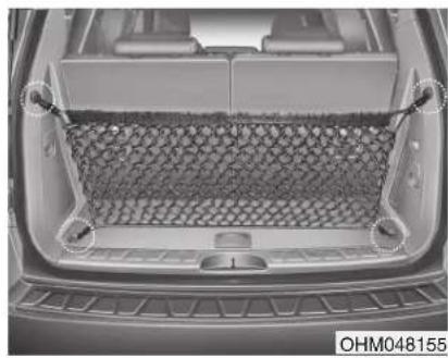 Top-down view of a car trunk with mesh mesh pattern, no visible text or symbols