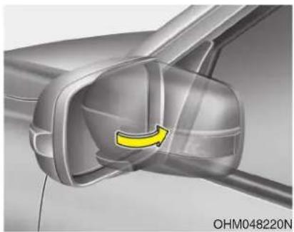 Close-up of a car's side panel showing a yellow arrow indicating rotation or movement (no text or symbols)