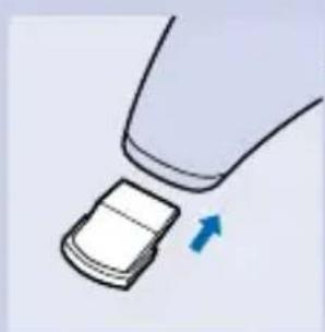 Illustration of a hand holding a small object with an arrow indicating direction (no text or symbols).