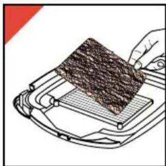 Illustration of a hand using a griddle to cut a textured material on a metal tray (no text or symbols)