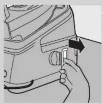 Hand holding a mechanical component with an arrow indicating direction (no text or symbols visible)
